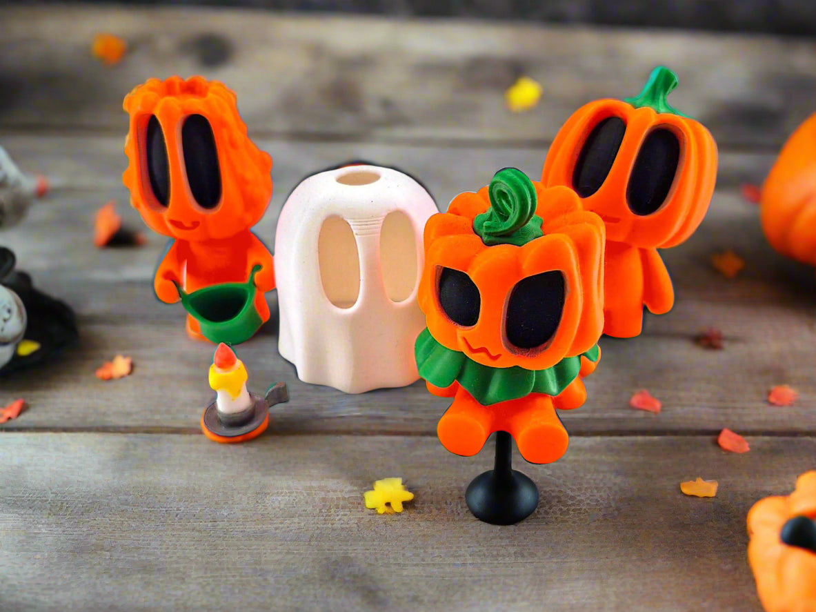 Three orange pumpkin-shaped figures with black faces and green leaves on a white background