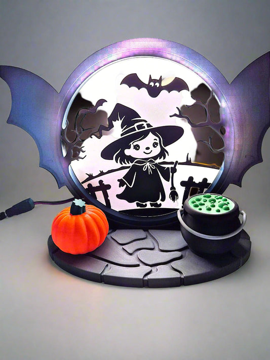 Halloween-themed decorative light with a witch, pumpkins, and bats 